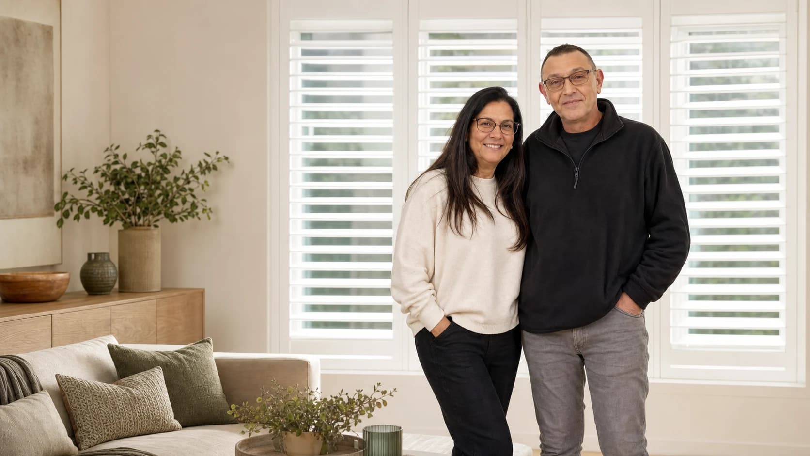 Kenny and Rama, co-founders of Shutters U Fit, in a room with plantation shutters